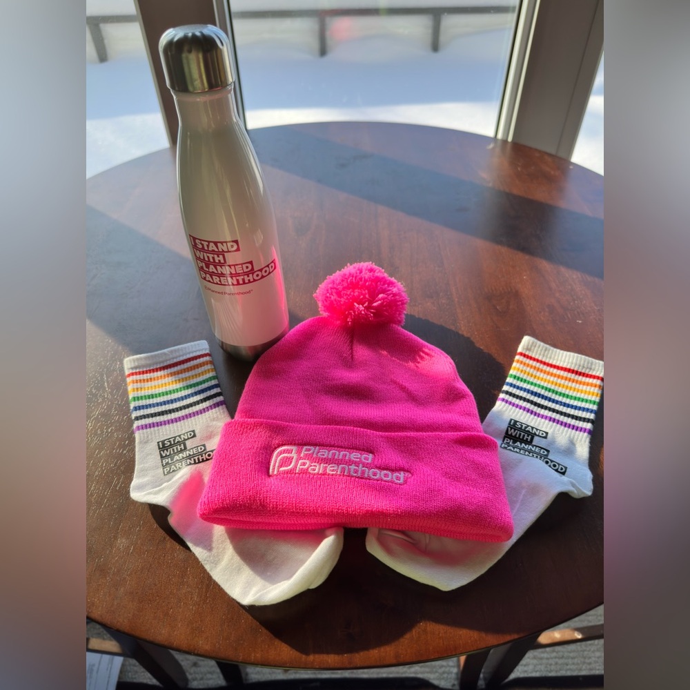 Show your Planned Parenthood support w/ water bottle, hat w/pom pom & socks.